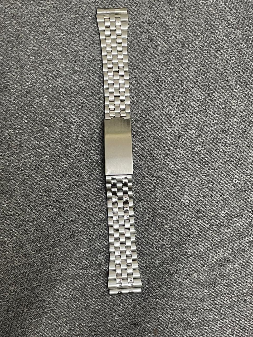 Polished Jubilee-style stainless steel watch bracelet in 18mm with brushed edges and folding clasp